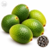 Green gac fruits with an inset showing dark sculptured seeds